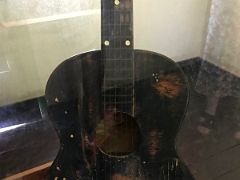 04B A glass case displays one of the first guitars Bob Marley ever owned Trench Town Culture Yard Kingston Jamaica